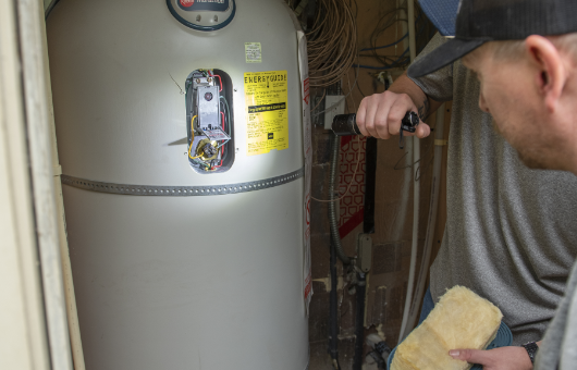 Petersen Plumbing checks a water heater.